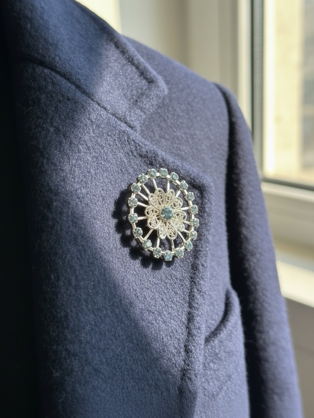 Vintage Silver Tone Pinwheel Filigree Brooch Adorned with Blue/Grey Rhinestones